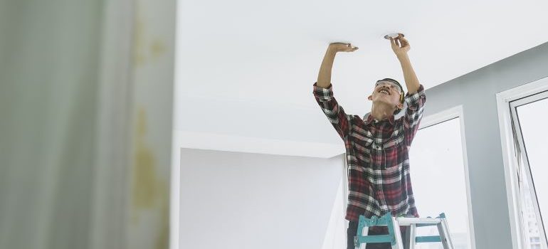 person installing a smoke detector