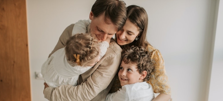 A family hugging, happy to know they're protected by the best home warranty plan.